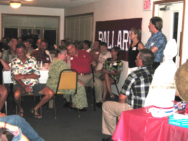 Audience, This side of table: Greg Peterson, Janice and Rod Halverson, Gary and Dixie (Kahler) Minear.  Other side: Allen Uran, Joyce ODonnell, Dan ODonnell, Gary Peterson.  Standing: Joetta (Geer) Johnson, Dan Billings.  Seated: George Sandquist.